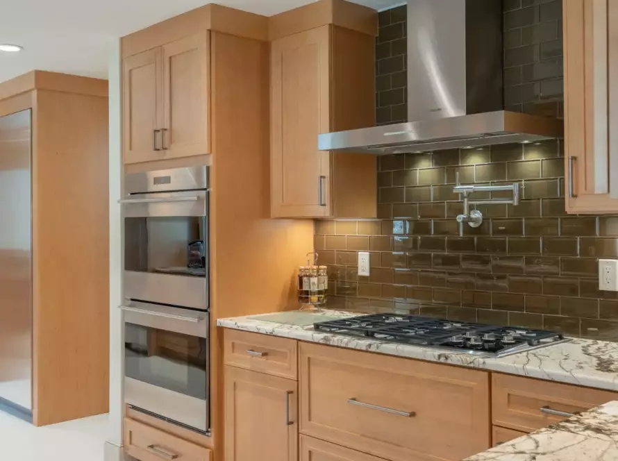 Cozy kitchen interior with white cabinets and wood accents, great for buying kitchen cabinets that combine style and function.