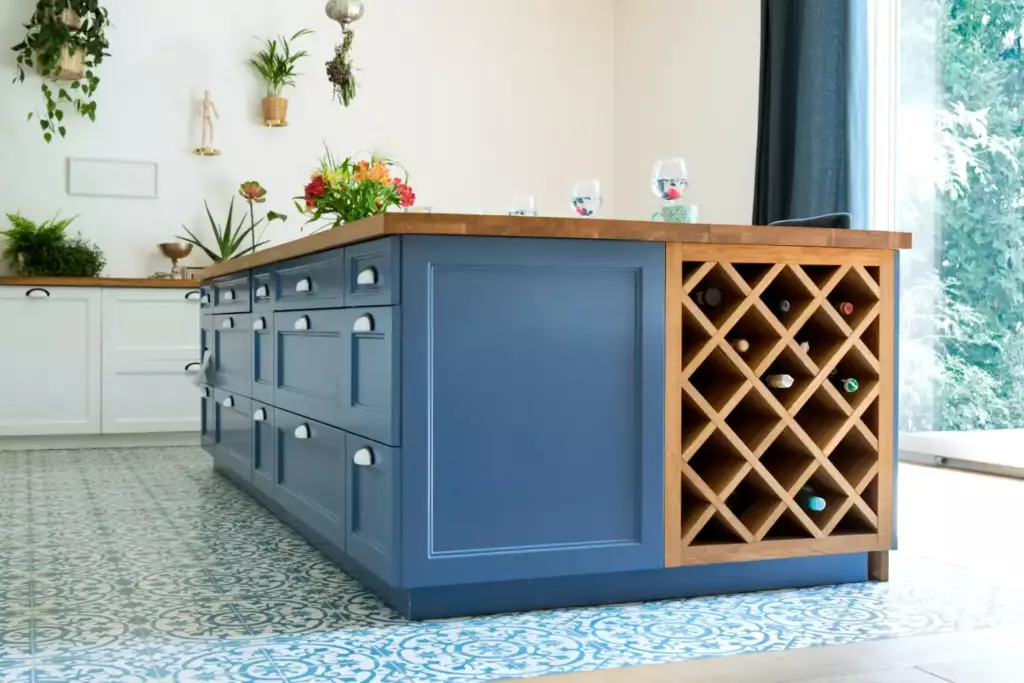 Modern kitchen with a navy blue island and wine rack, ideal inspiration for where to buy kitchen cabinets